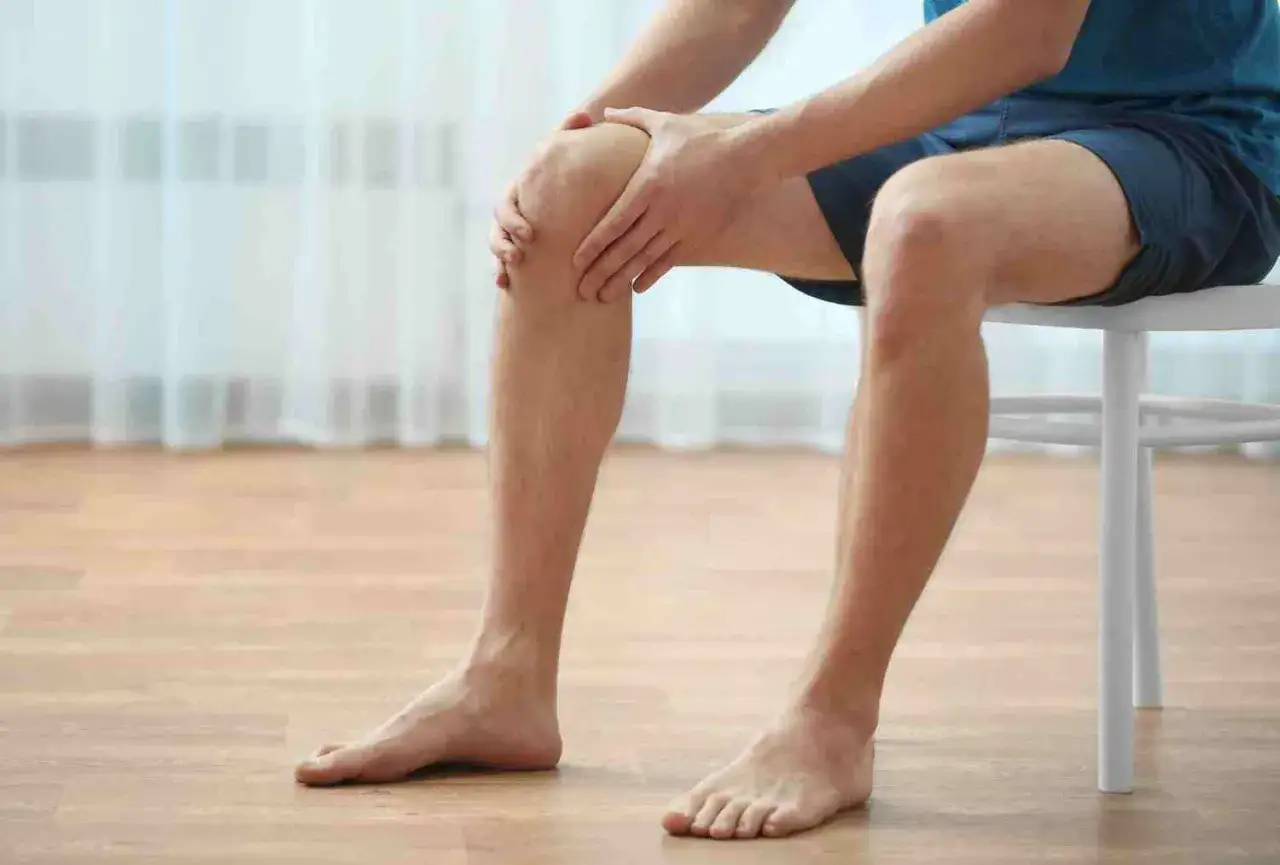 Hombre con dolor de rodilla, buscando alivio con sinovitis tratamiento fisioterapia.